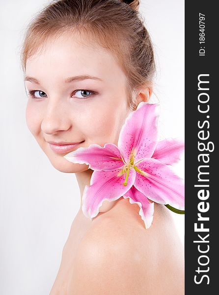 Close-up studio portrait of beautiful teenage girl  with lily flower over white. Close-up studio portrait of beautiful teenage girl  with lily flower over white