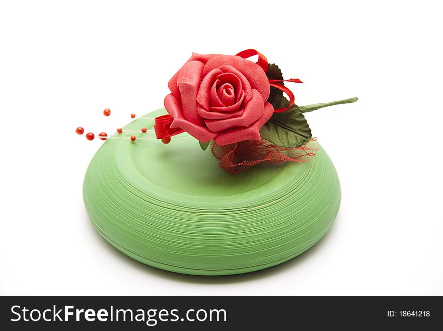 Red rose with pearls on ceramics plate