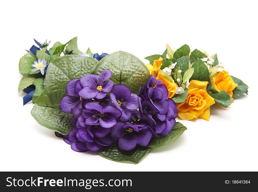 Artificial bunches of flowers onto white background