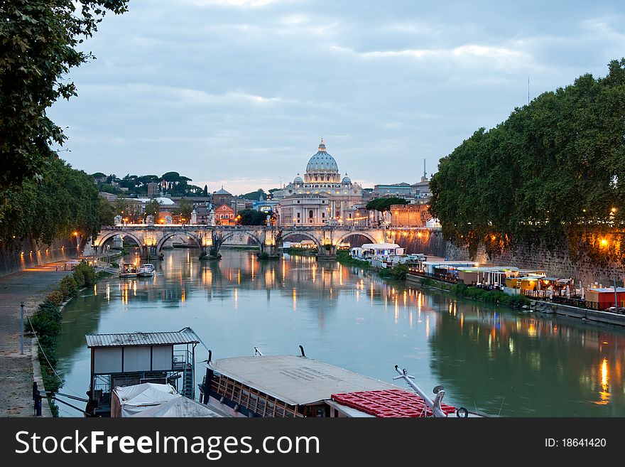 Evening view at the Angelo bridge and St. Peter's Basilica in Rome, Italy