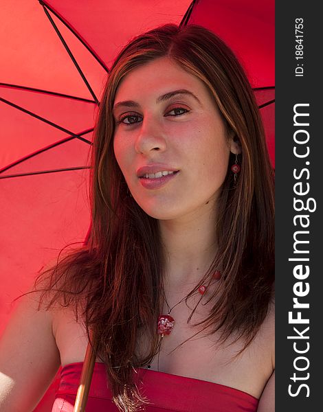 View of a beautiful woman with red dress and umbrella. View of a beautiful woman with red dress and umbrella