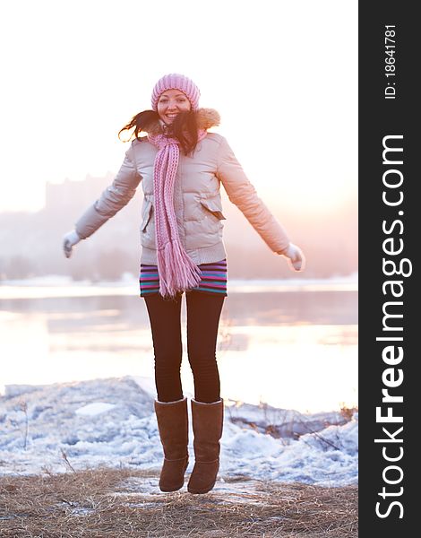Positive smiling girl in winter clothes - jumping