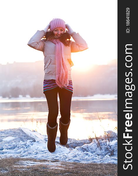 Positive smiling girl in winter clothes - jumping