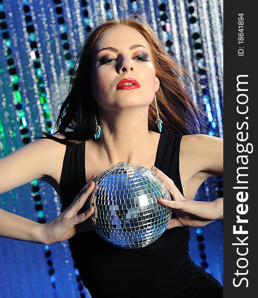 Attractive woman dancing in the disco with disco ball. Attractive woman dancing in the disco with disco ball