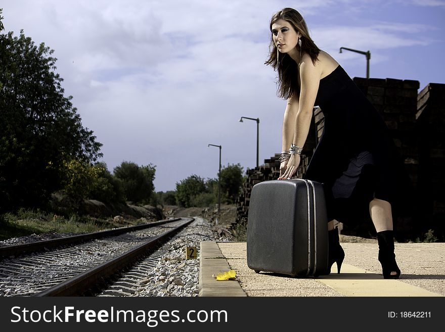 View of a beautiful woman with black dress upset with not catching the train