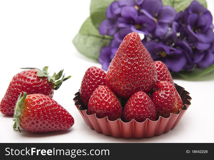 Strawberries in the back form with bunch of flowers