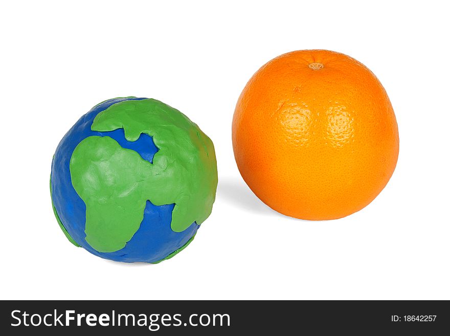 Plasticine globe and an orange on a white background. Plasticine globe and an orange on a white background