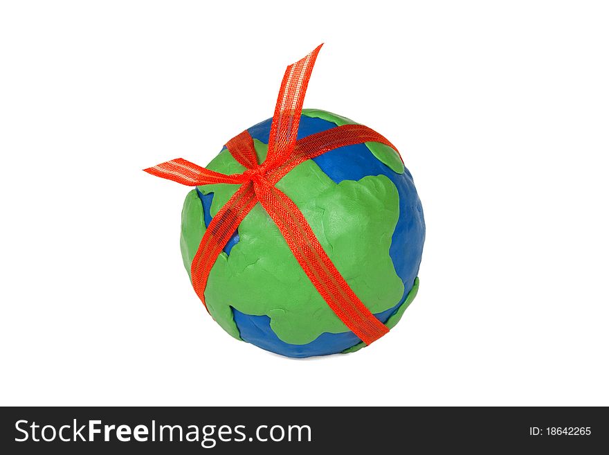 Plasticine globe with a red bow on white background. Plasticine globe with a red bow on white background