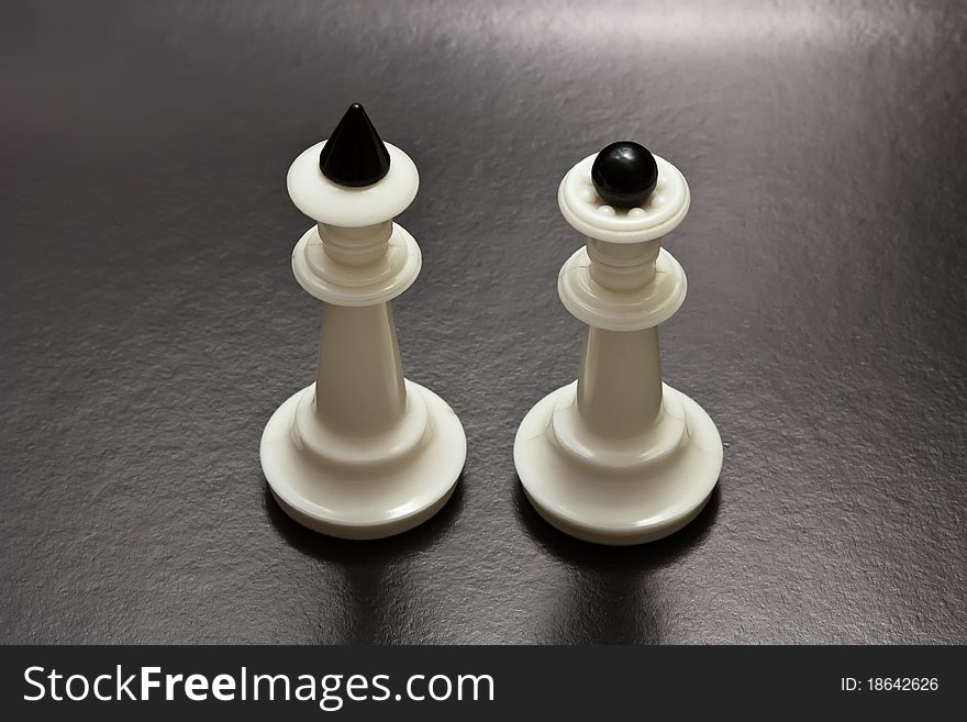 White chess figure on a black background