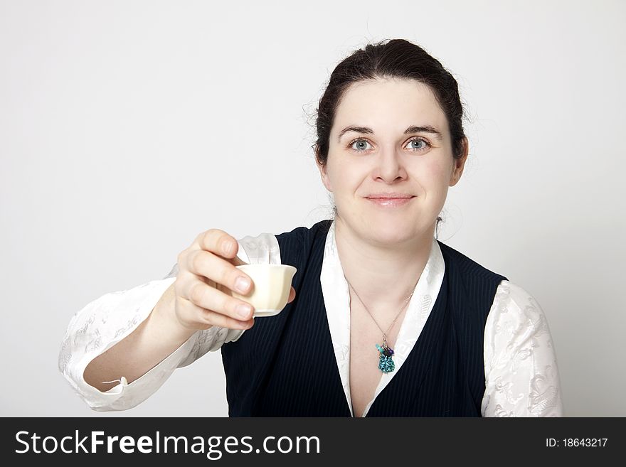 Woman in traditional tibetan dress with cup of tee