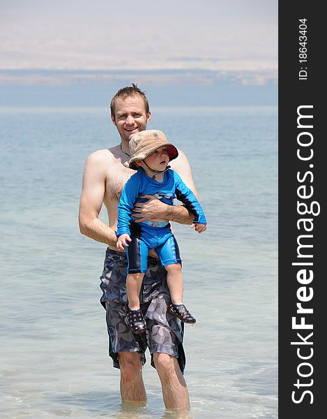 Father and young son swimming in Dead Sea, Jordan. Father and young son swimming in Dead Sea, Jordan