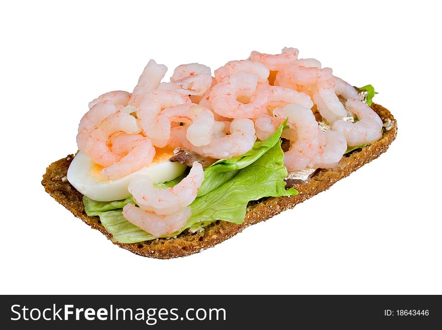 Open sandwich from rye bread, with salad, shrimps and anchovy.  Isolated white background. Open sandwich from rye bread, with salad, shrimps and anchovy.  Isolated white background.