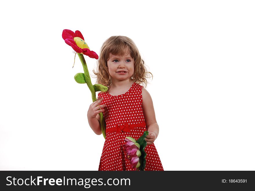 The girl in red dress holding a large toy flower. The girl in red dress holding a large toy flower