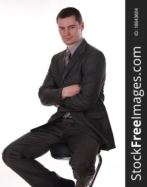 Businessman in a suit sitting on a chair. Businessman in a suit sitting on a chair