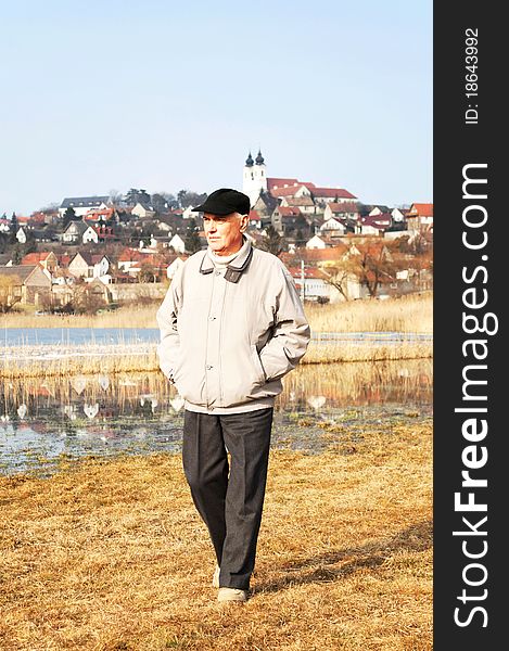 Senior man is walking at Central-Lake in Tihany, Hungary