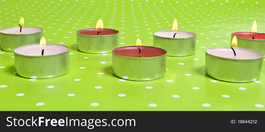 Candles isolated on green background