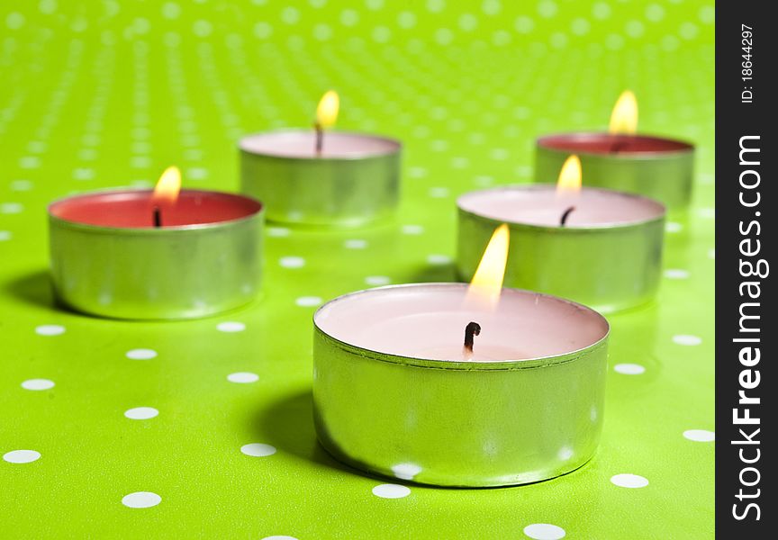 Candles isolated on green background