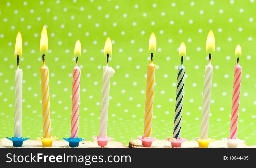 Candles isolated on green background