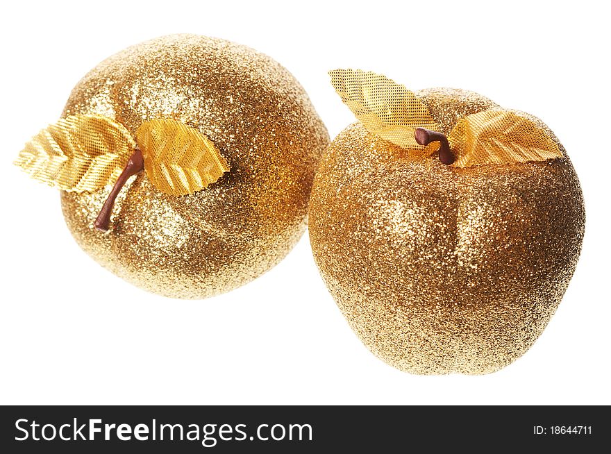 Golden apple lying on a white background
