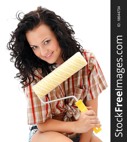 smiling craftswoman with a roller brush in her hand. smiling craftswoman with a roller brush in her hand