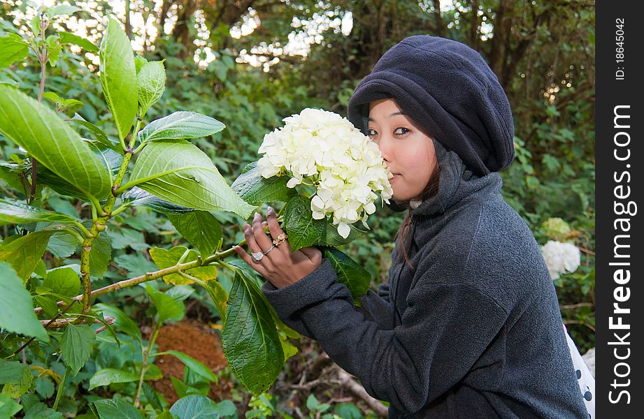 Young woman smelling flower