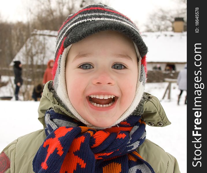 A smiling boy at winter background. A smiling boy at winter background
