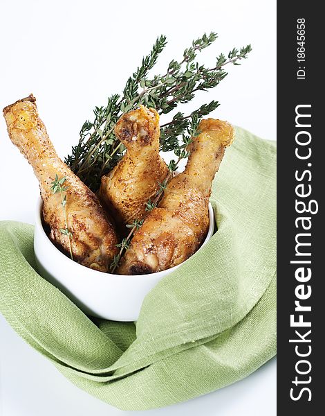 Roasted chicken legs with thyme in a bowl