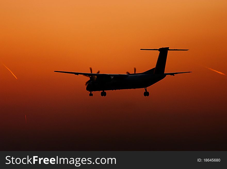 Turboprop plane landing in sunset. Turboprop plane landing in sunset