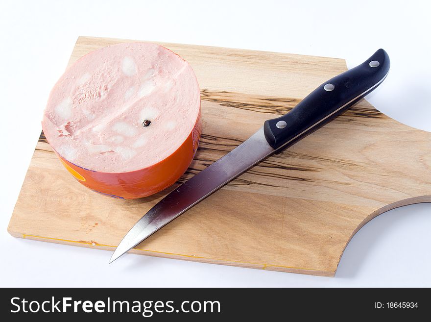 Mortadella and knife with knife in white background