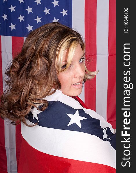 A photograph of an American lady with the American Flag in The Background. A photograph of an American lady with the American Flag in The Background.