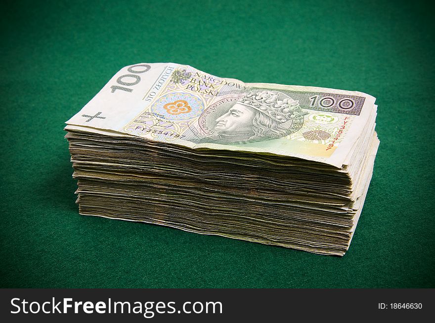 Stack of hundred zloty bills on green casino background. Stack of hundred zloty bills on green casino background