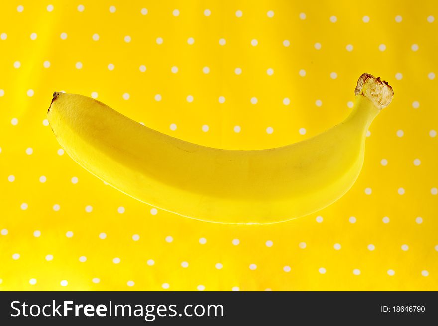 Ripe banana on yellow background