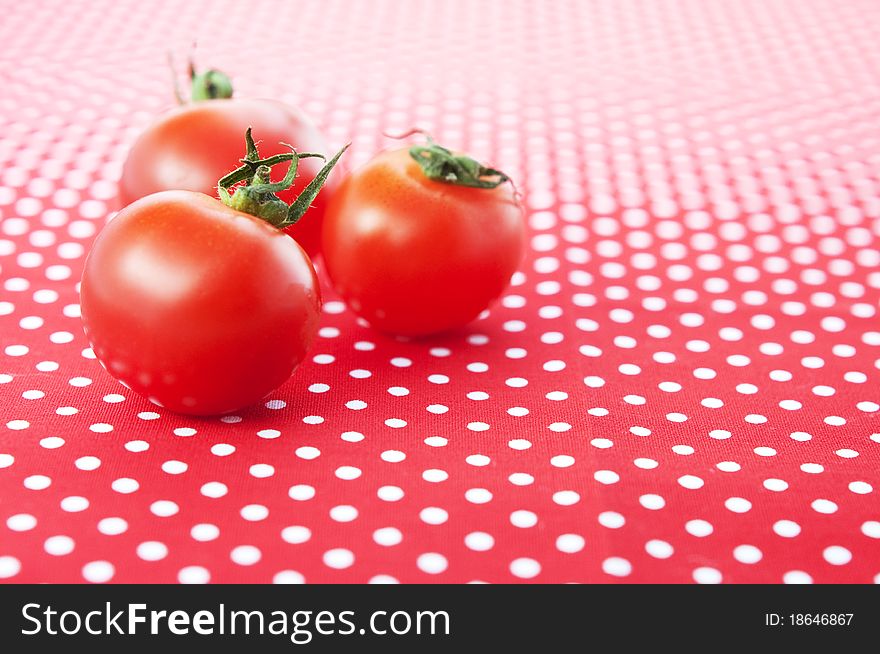 Cherry tomatoes on a red polka dot cloth