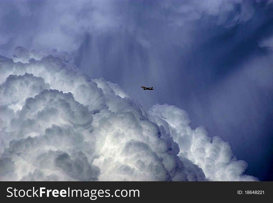 Aircraft flying near thunderstorm clouds. Aircraft flying near thunderstorm clouds
