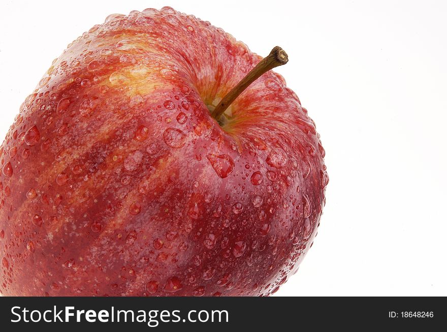 Organic Gala apple covered with drops of water isolated on white background