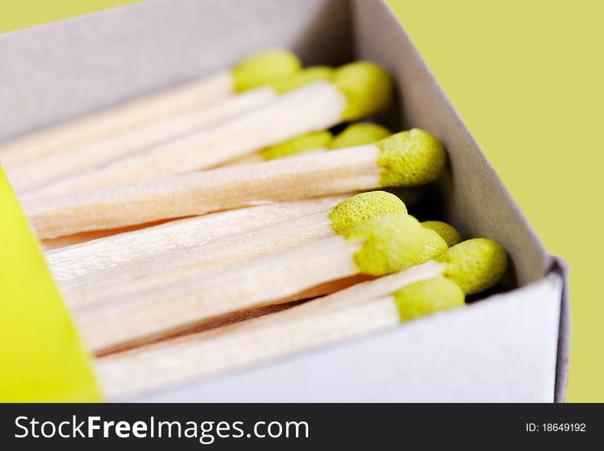 Part of green matchsticks in box isolated on green background. Part of green matchsticks in box isolated on green background.