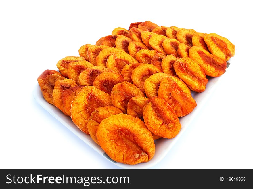 Dried peaches in trays isolated on white background.