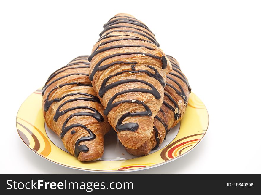 Croissant with chocolate on ceramics plate