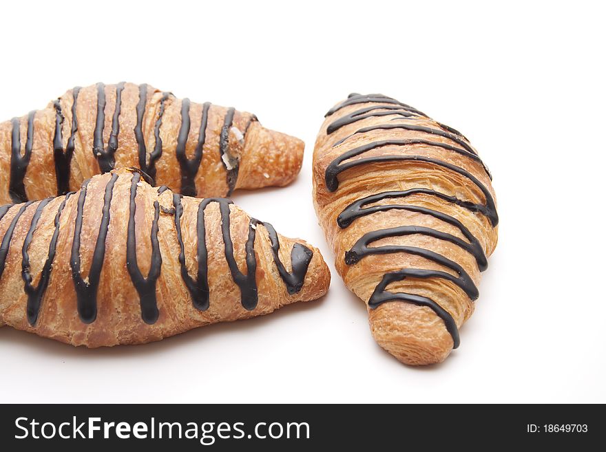 Croissant with chocolate onto white background