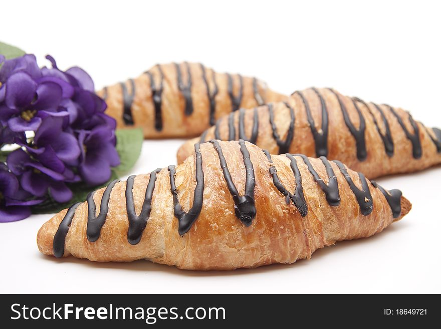 Pastry with chocolate and bunch of flowers
