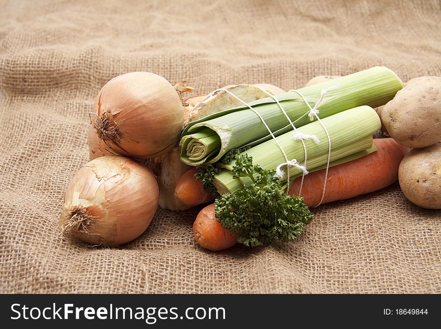 Soup vegetables with onions and potatoes on potato bag