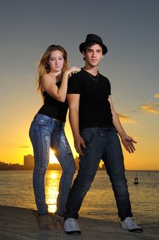 Cool Young Couple Standing At Sunset Royalty Free Stock Images