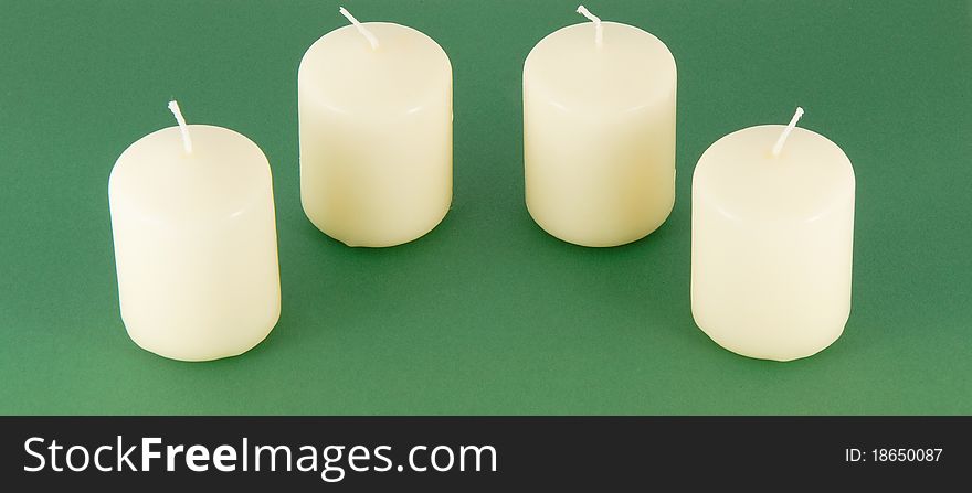 Set of candles on a green background