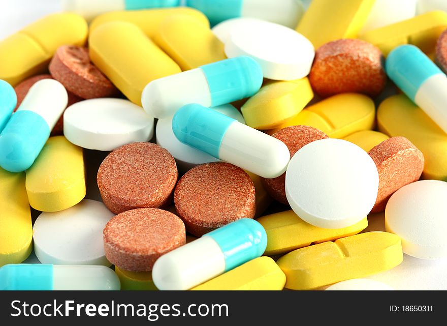 Close-up heap of colorful assorted pills and tablets