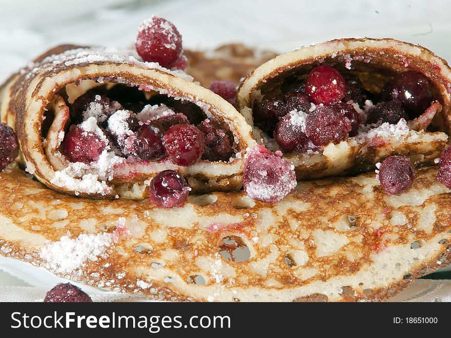 Pancakes with a red berry and sugar close up. Pancakes with a red berry and sugar close up