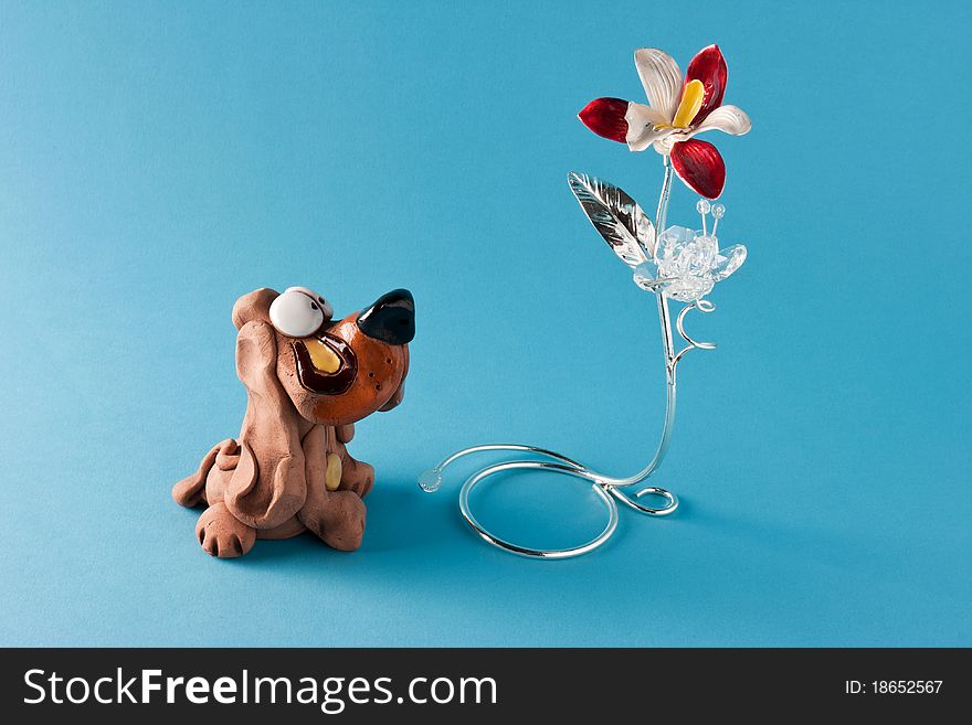 Cute dog ornament that looks at a flower. Cute dog ornament that looks at a flower