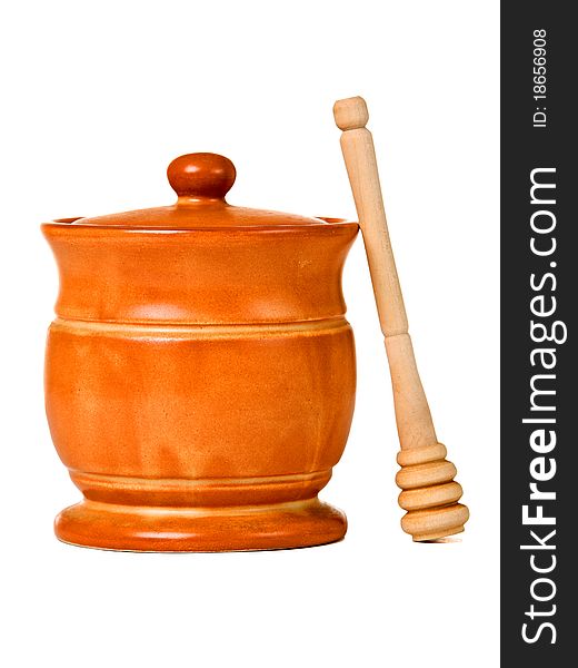 Ceramic jar with honey and wooden stick, isolated on white