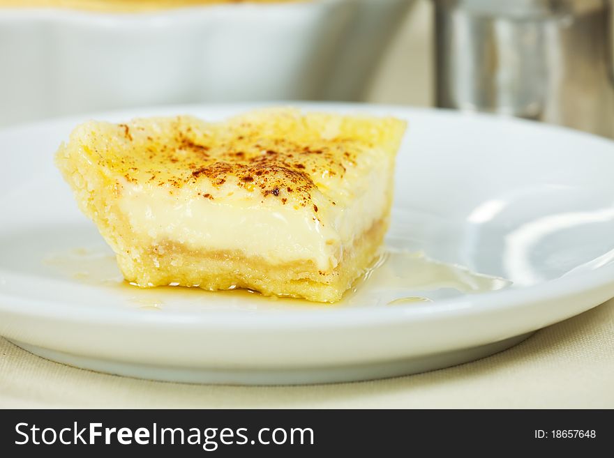 Open pie or flan portion with sugar cream flavor. Very shallow depth of field. Open pie or flan portion with sugar cream flavor. Very shallow depth of field.