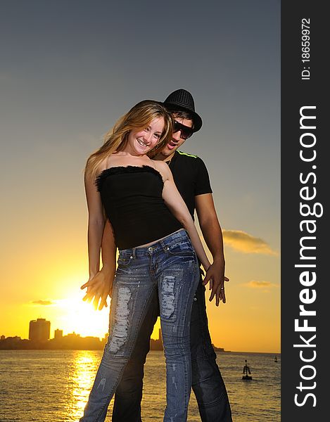 Portrait of young cheerful hispanic couple standing at sunset. Portrait of young cheerful hispanic couple standing at sunset