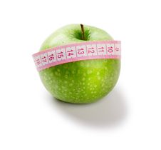 Green Apple And Measuring Tape Of The Tailor Stock Photography
